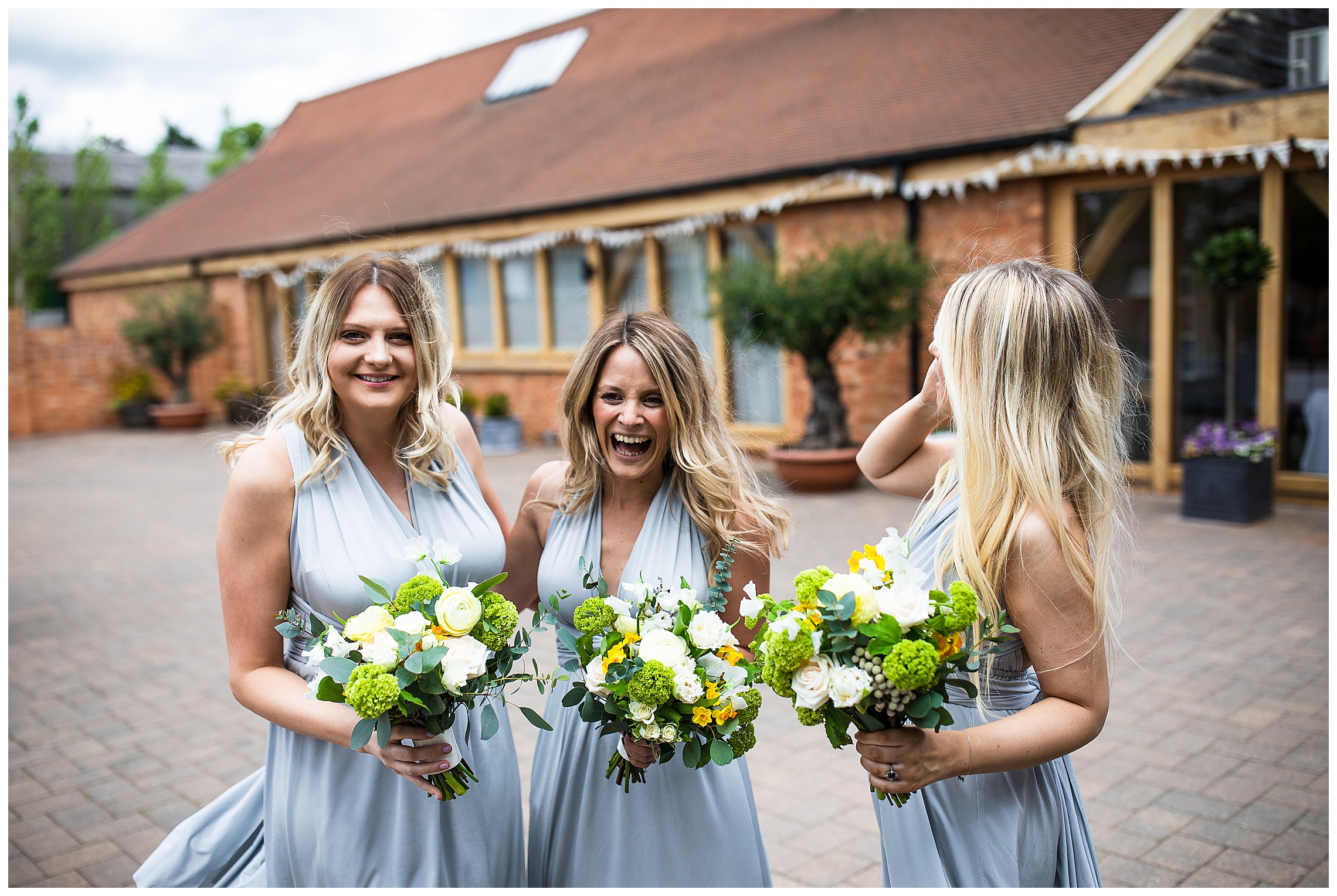 bridesmaids in baby blue wrap dresses with yellow flowers