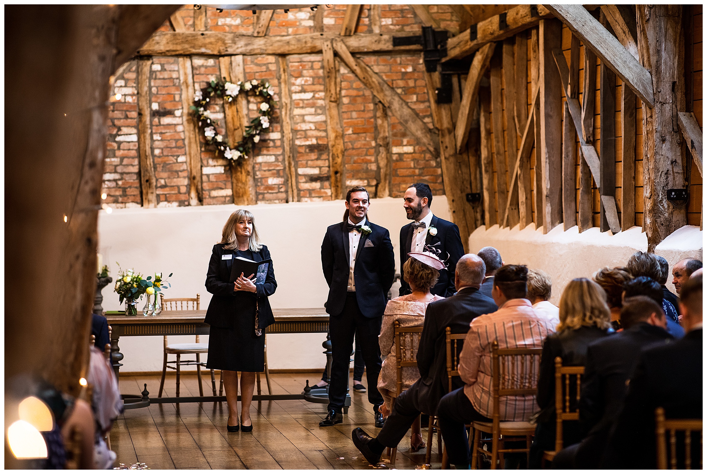 groom waiting at aisle in rickety barn at bassmead