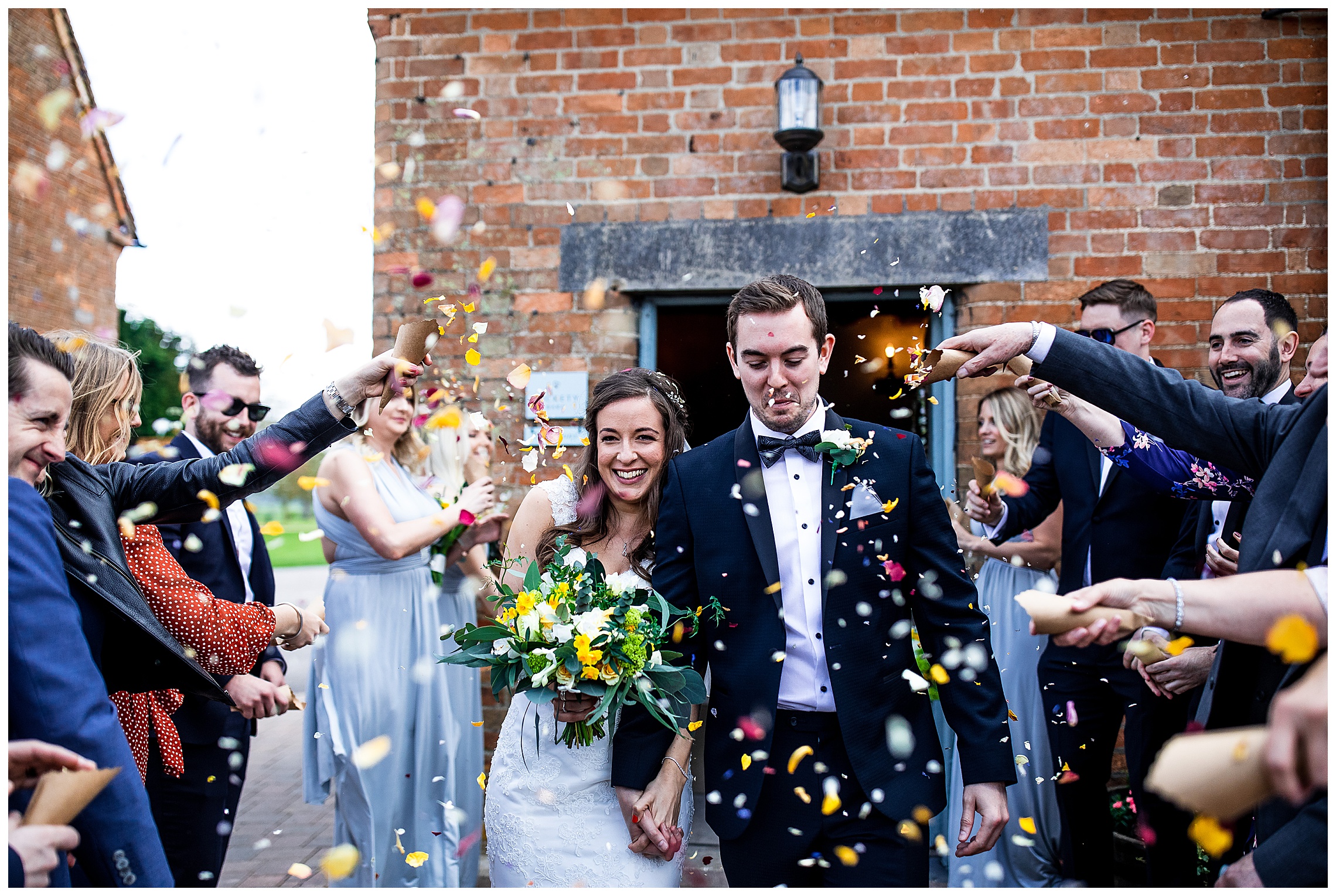confetti being thrown at wedding guests