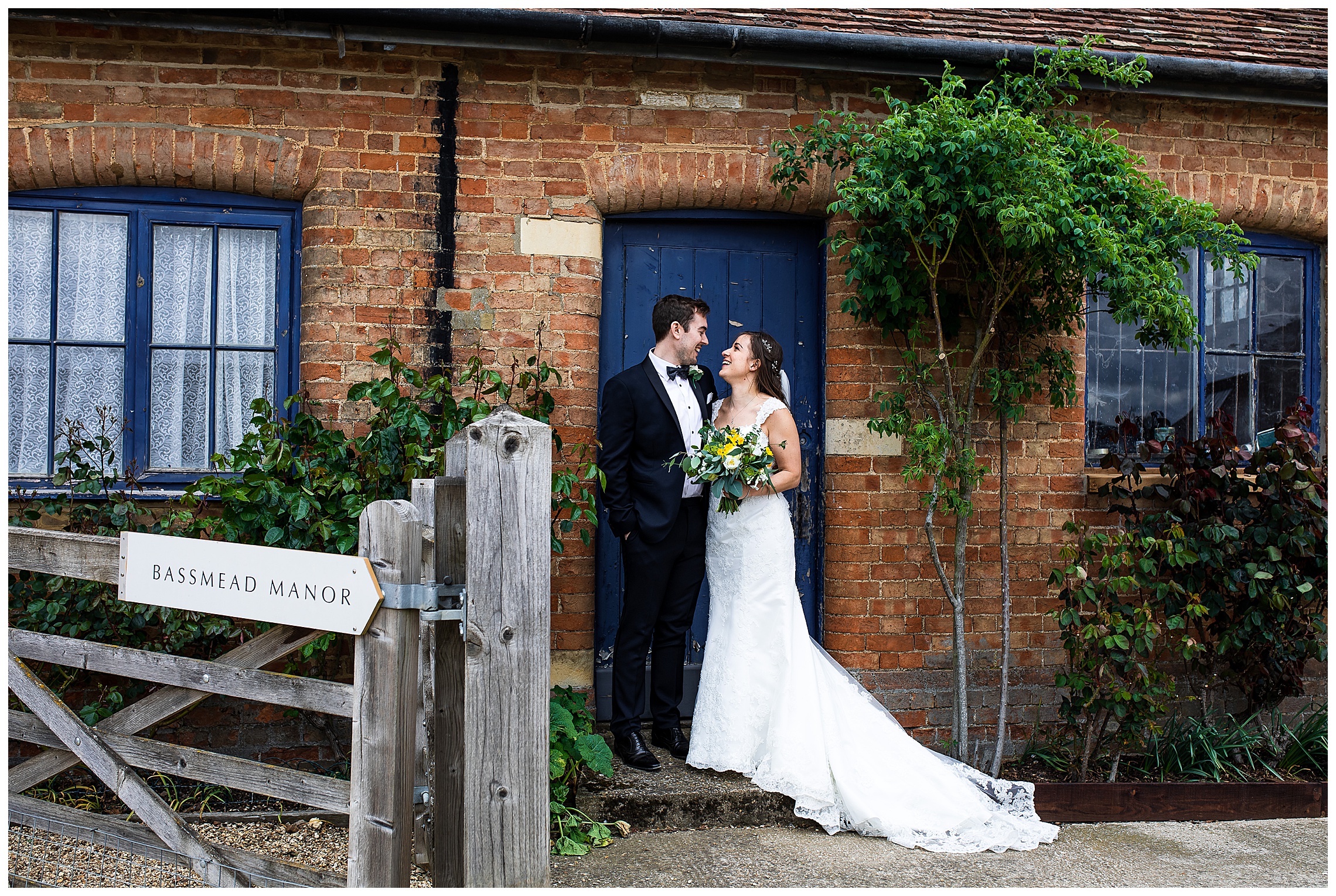 bride and groom against blue door at farm venue