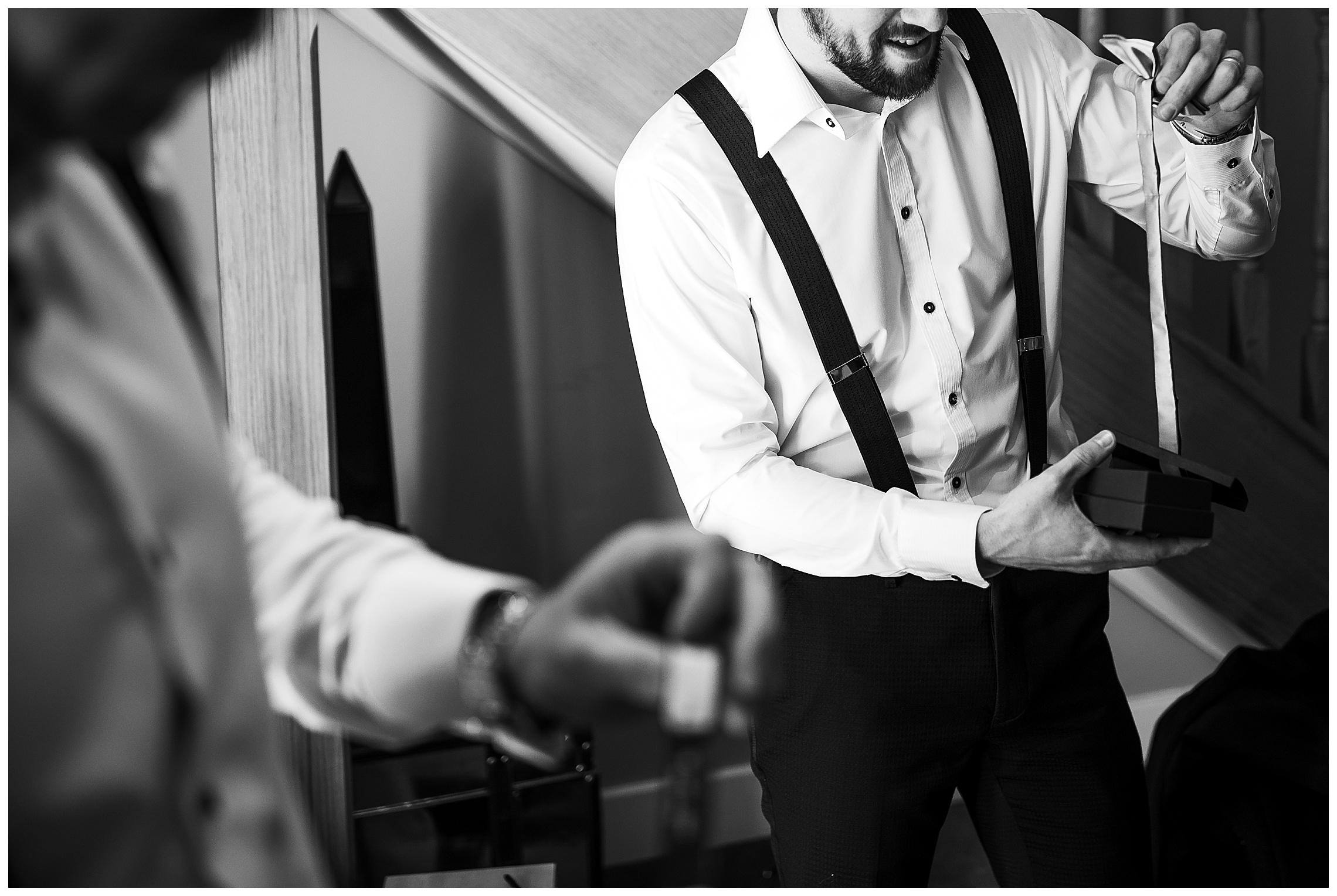 groom looking at ties