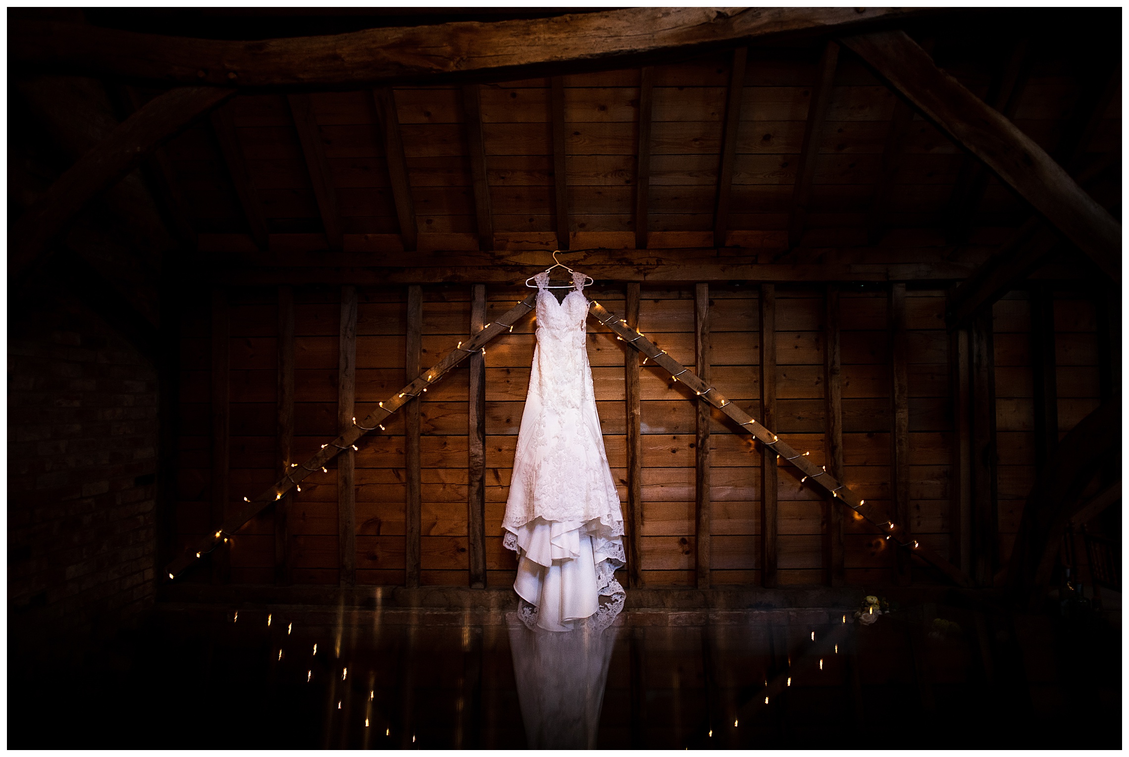 wedding dress surrounded by fairy lights at bassmead manor barns