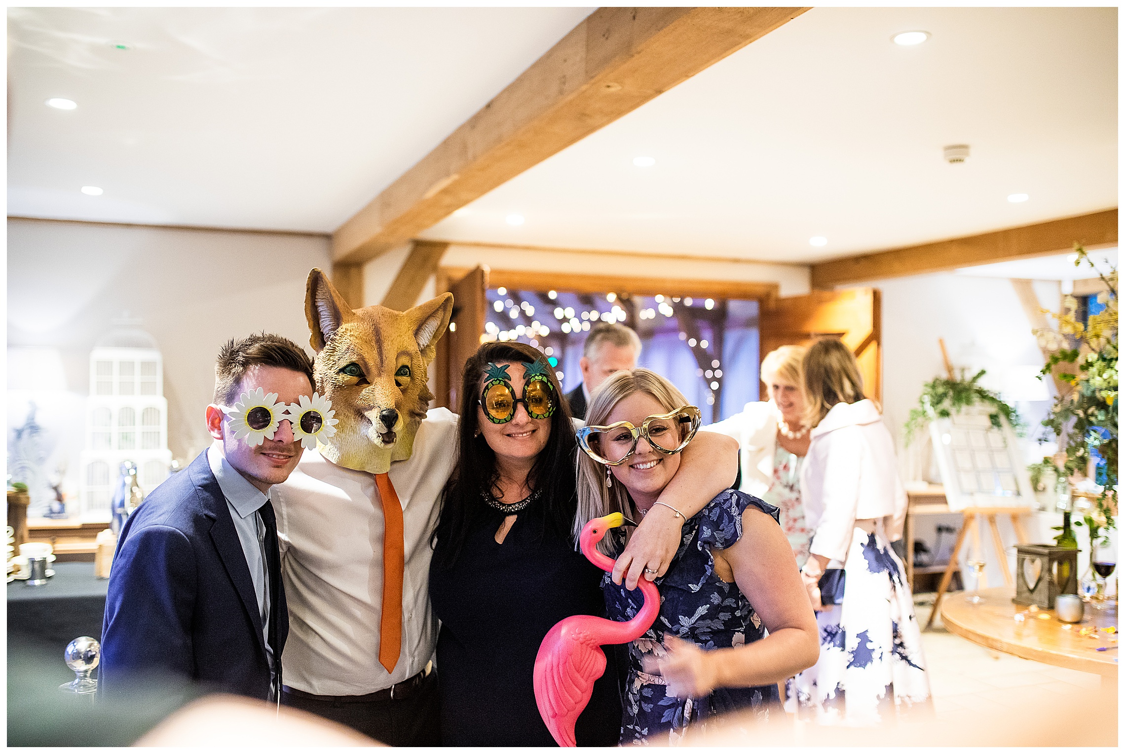 wedding guests with props inside bassmead manor barns at Photo Booth