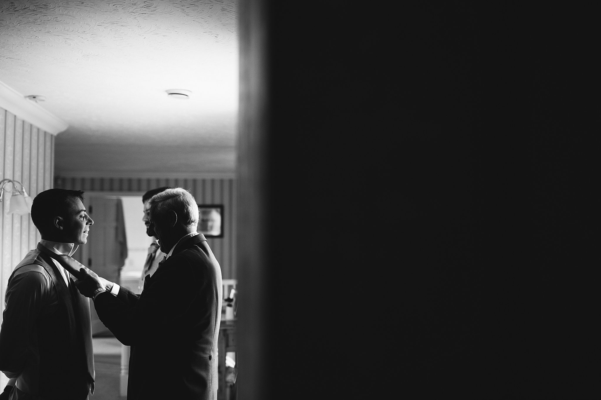 groom and grooms father altering tie