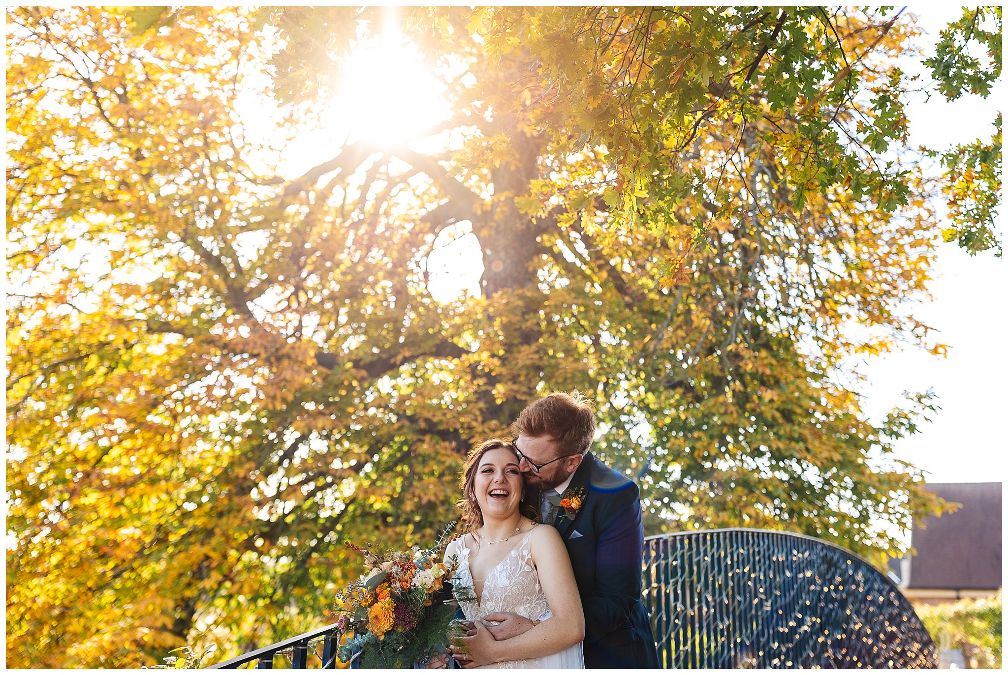bassmead manor barns autumn wedding with sun flare through trees
