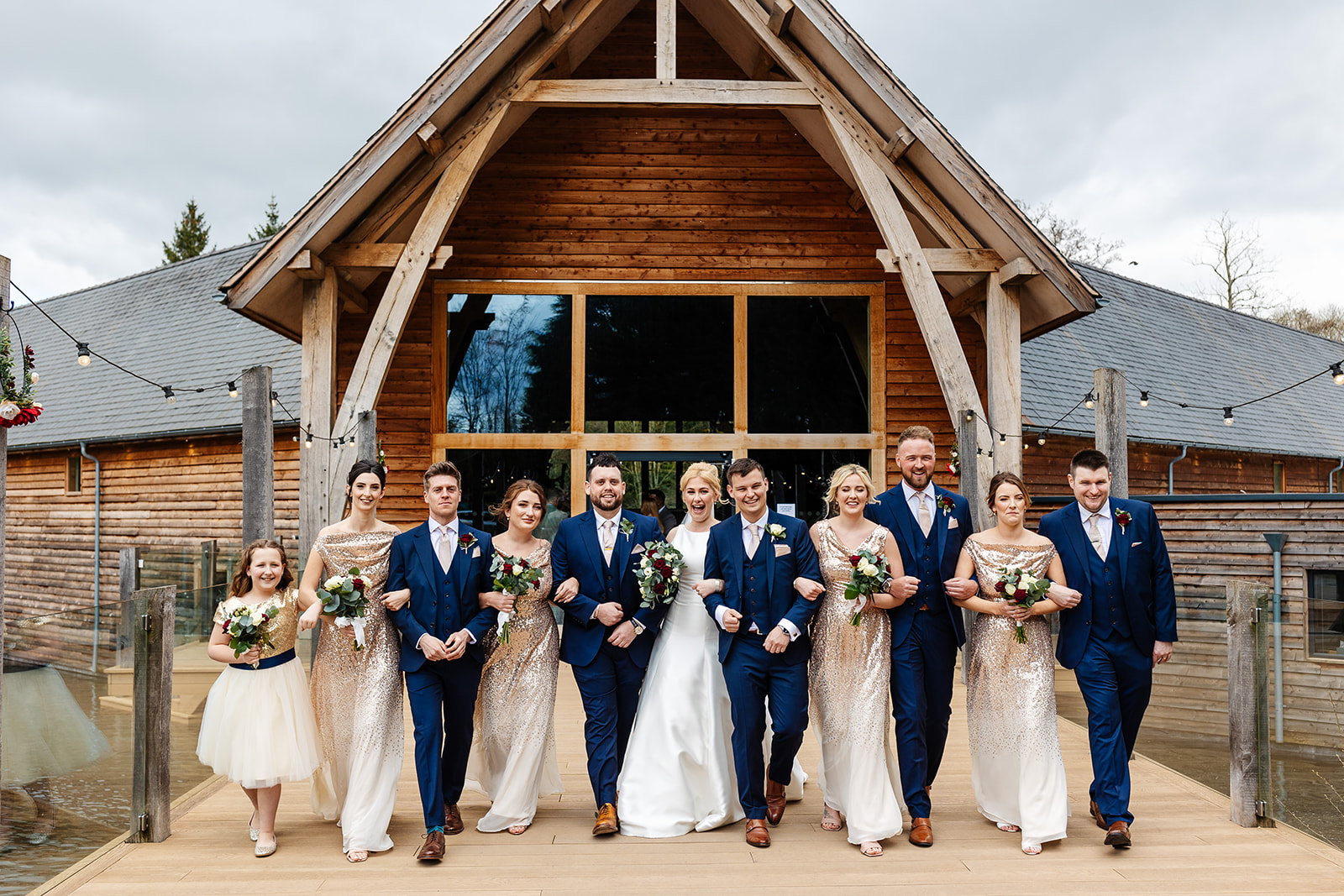 bridesmaids and groomsmen stood outside mill barns wedding venue 