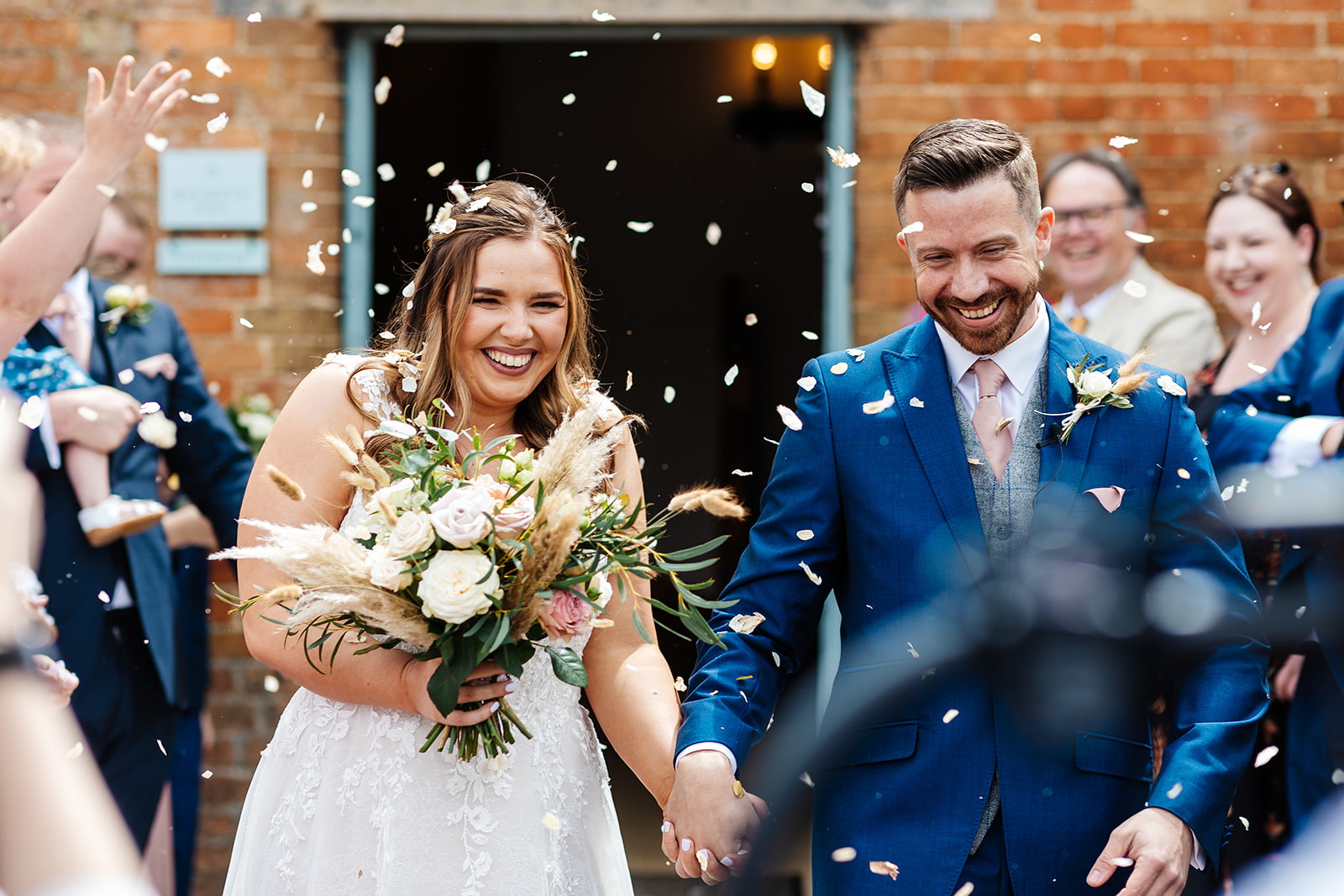 Couple walk out of ceremony and have confetti thrown 