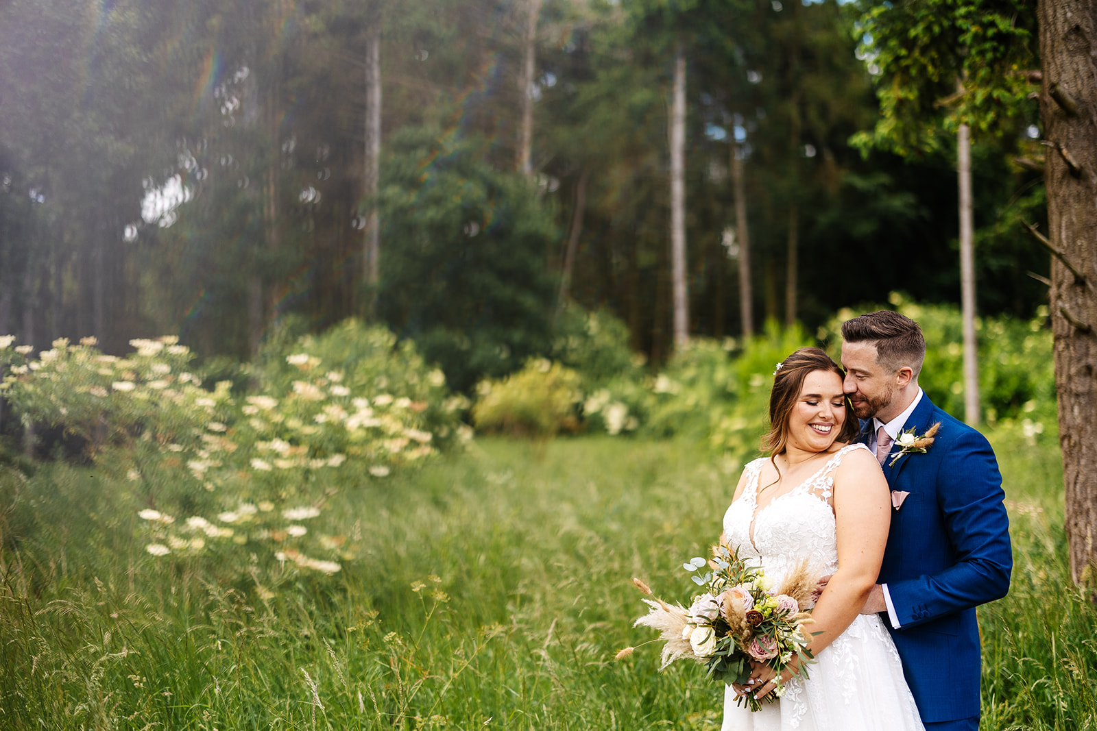 Couple embrace in the gardens of Bassmead 