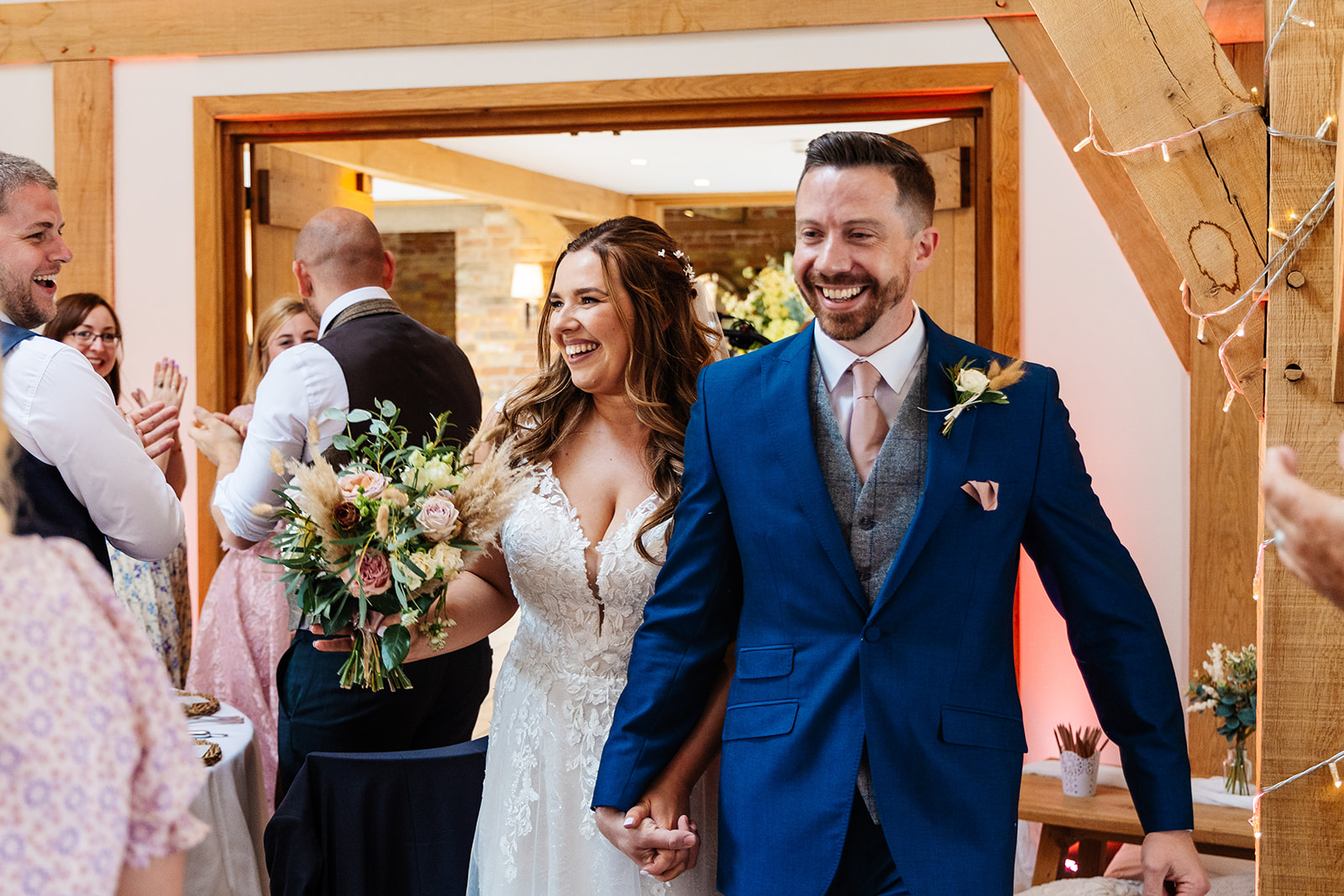 Couple enter wedding breakfast 