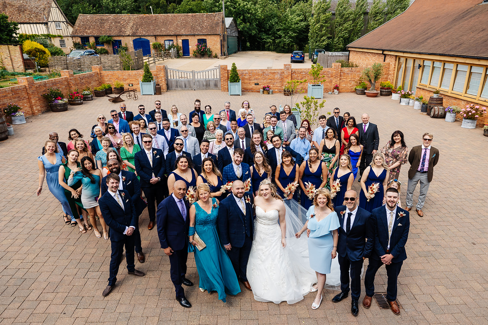 Group shot of all guests in courtyard of Bassmead 