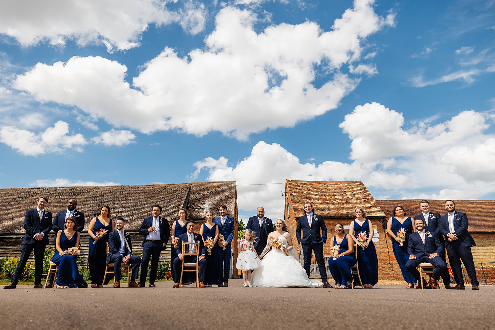 Couple with entire bridal party and Groomsmen outside in courtyard