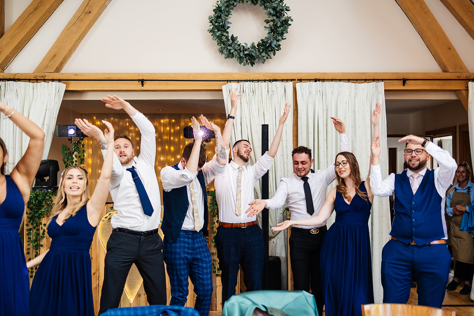 Guests stand and dance whilst couple enter wedding breakfast 