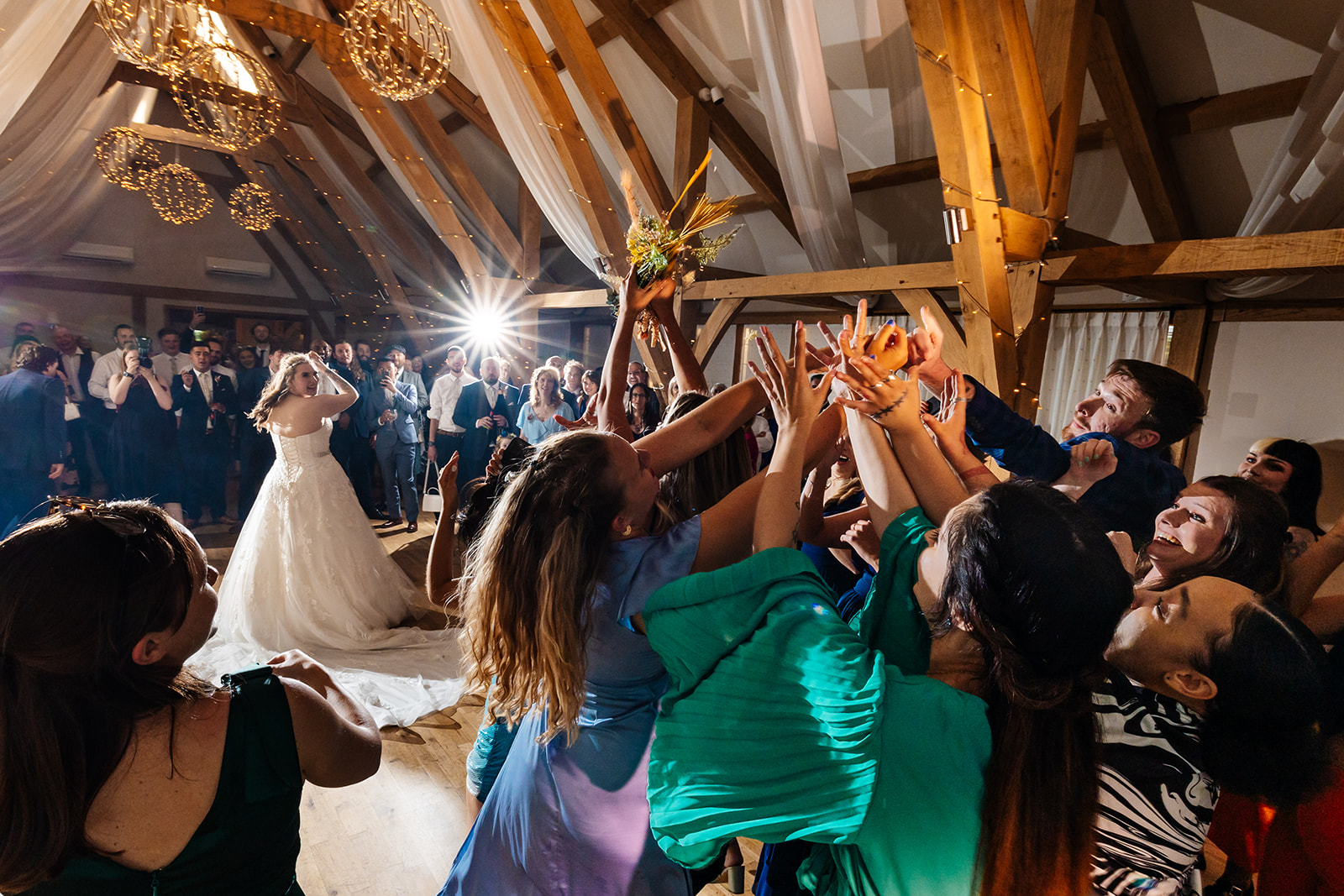 Guests run to catch brides bouquet