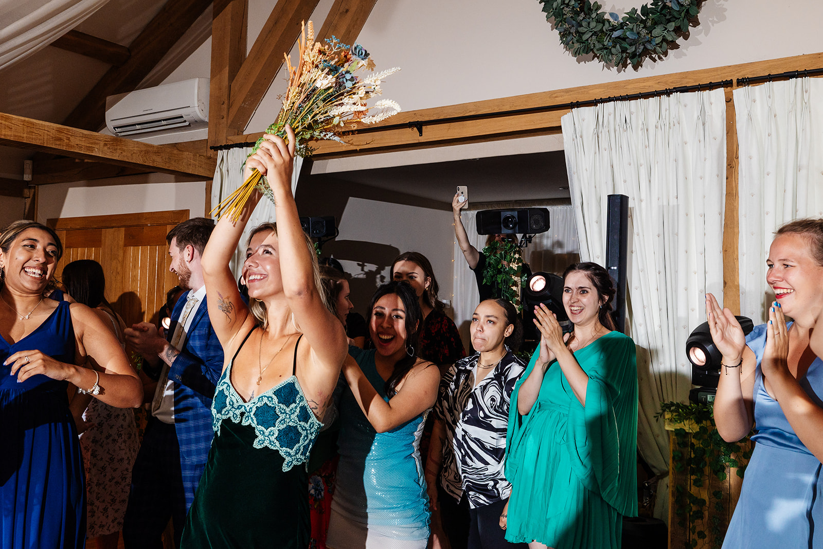 Guest catches brides bouquet 