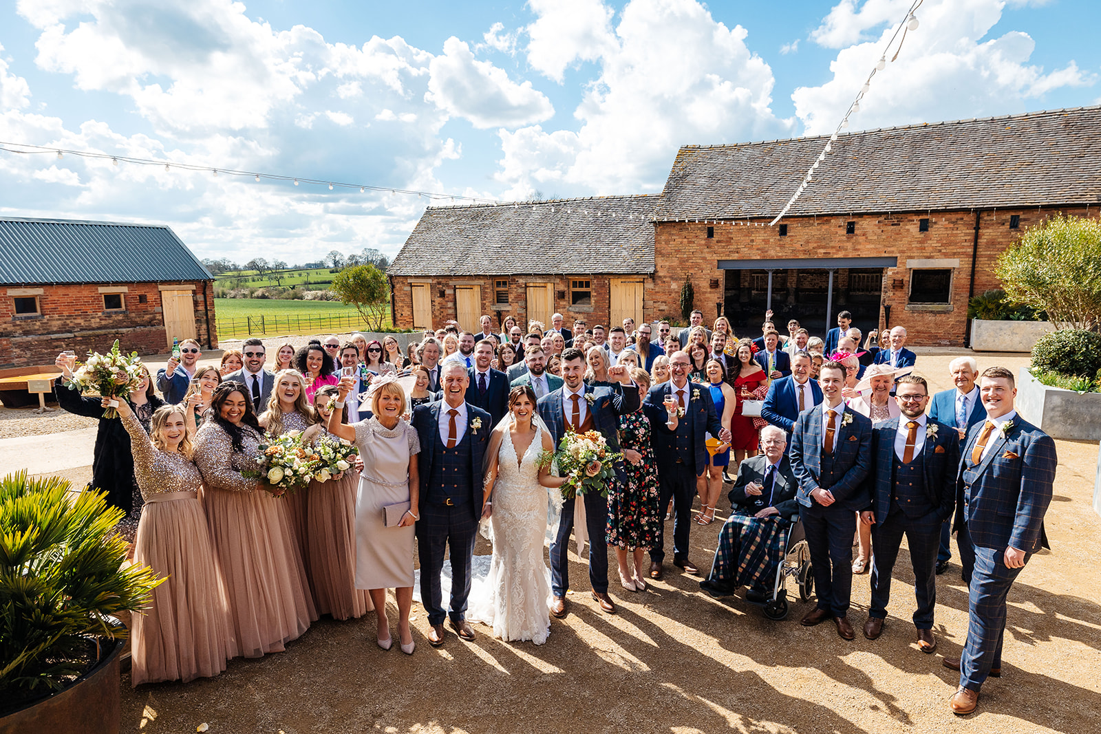 Group photo outside barns