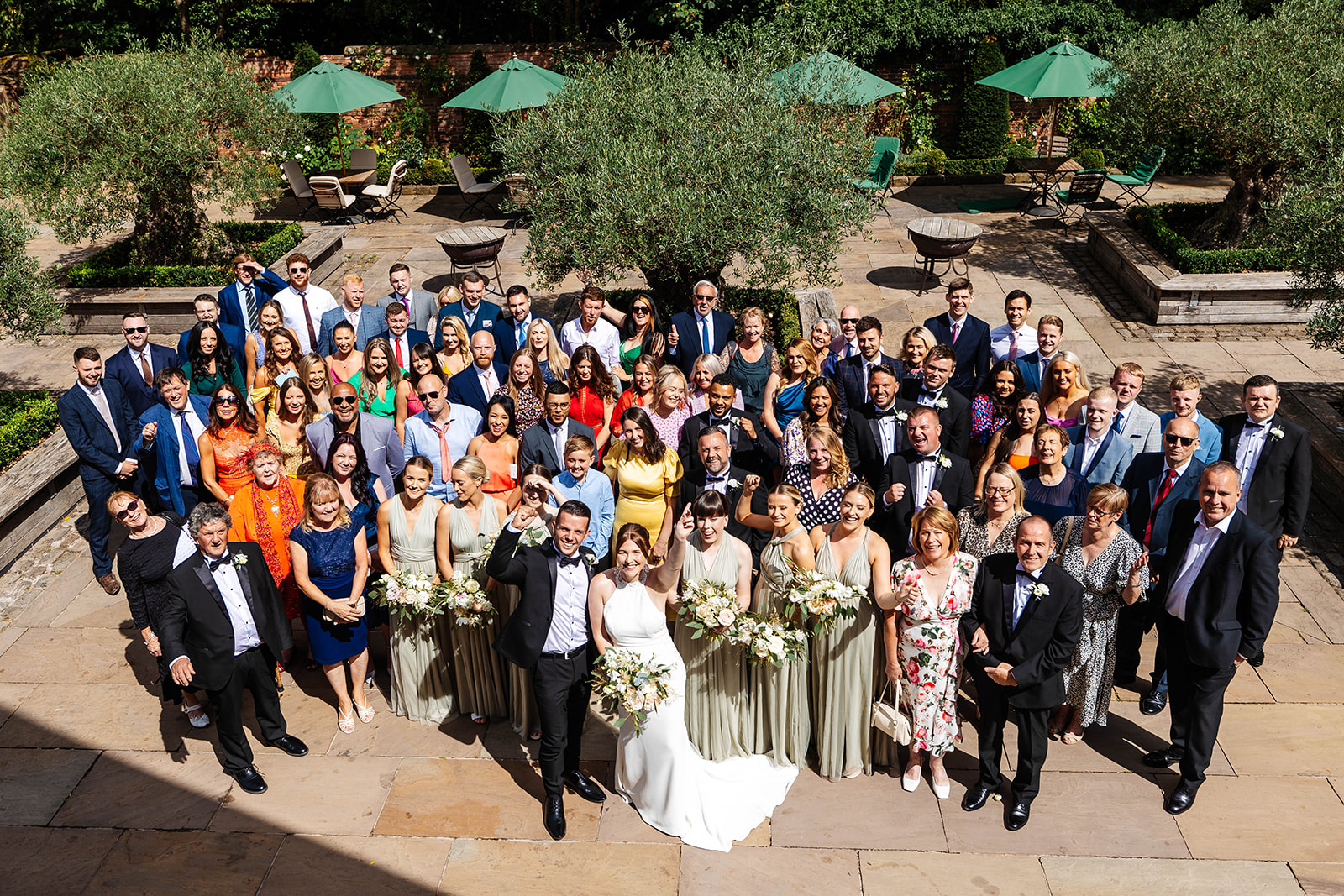 Group shot of all guests with bride and groom center 