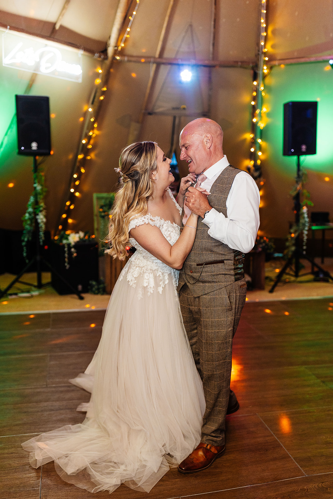 Bride and father share dance in tipi 