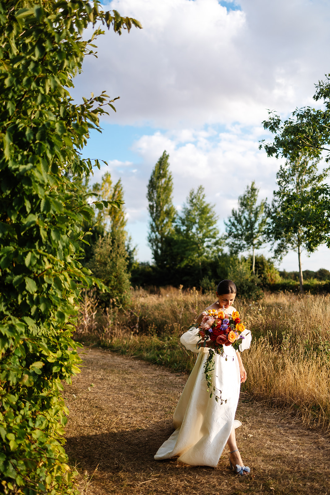 Bride walking in field 