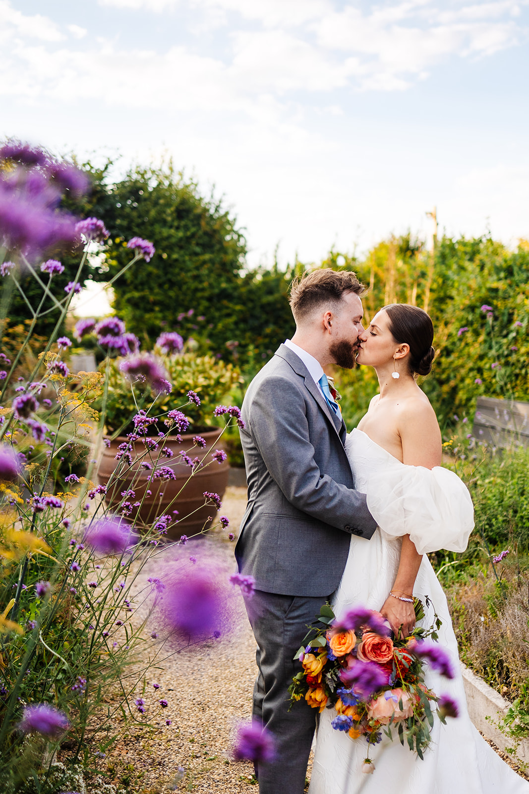 Couple in wildflower garden kiss 