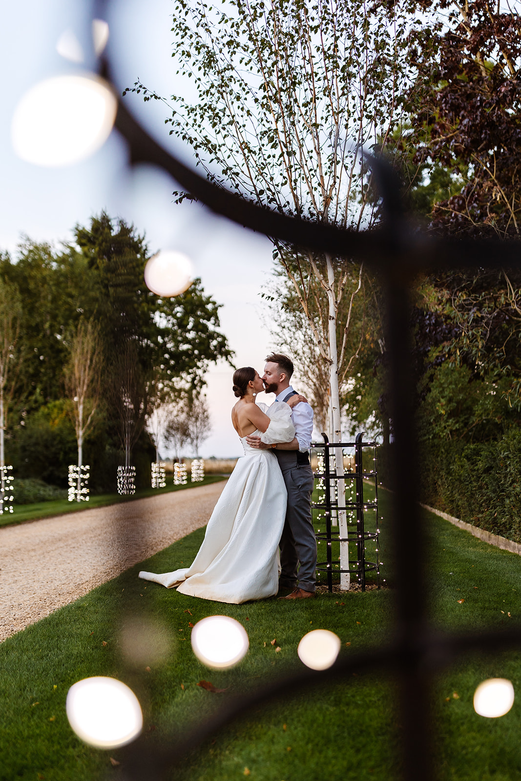 Couple kissing on driveway 