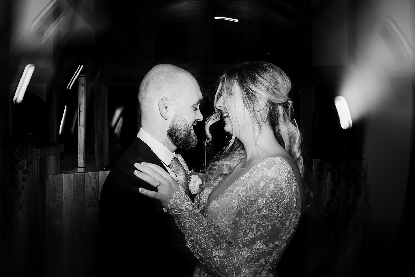 Couple share first dance, in black and white 