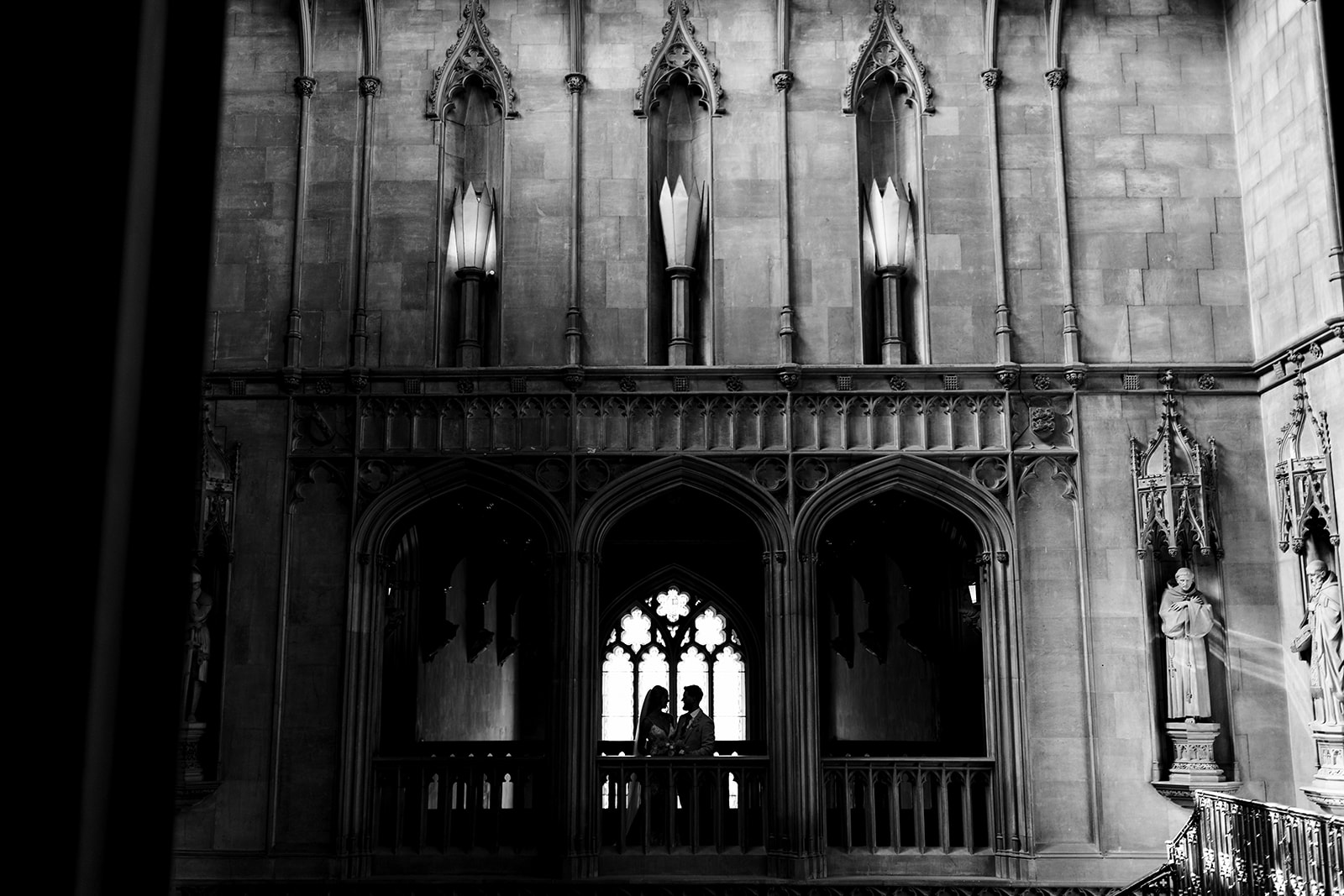 Bride and Groom on balcony inside Ashridge House, image is in black and white 