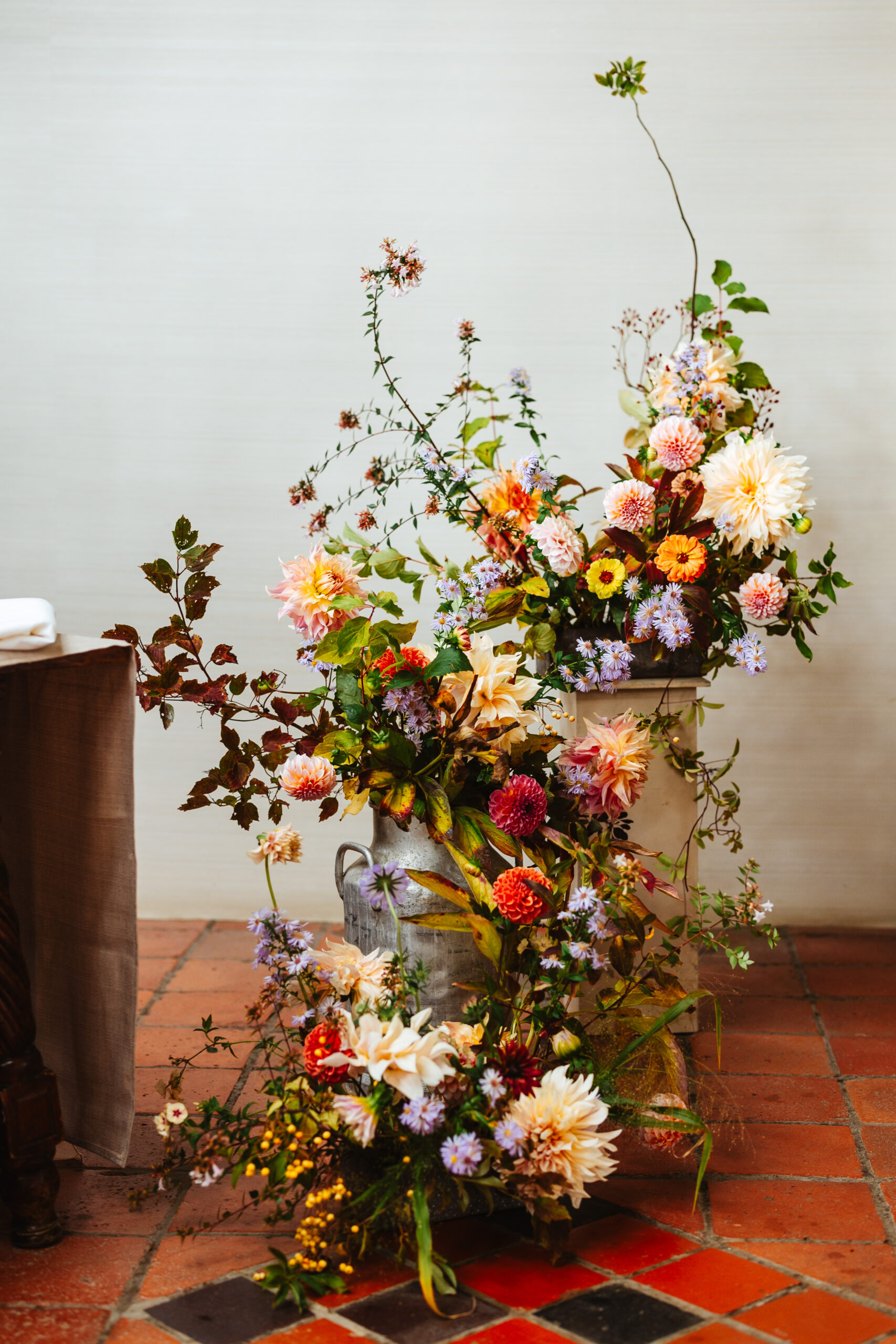 bright coloured autumnal dahlias and other flowers arranged in wild look at south farm 